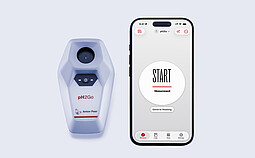 Anton Paar pH2Go digital pH meter next to a smartphone showing the pH2Go mobile app start screen with measurement controls.
