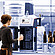 Technician loading a beverage can into the Anton Paar TPO 5001 Total Package Oxygen Meter; various bottles and cans shown for compatibility.