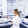 Technician handling sample tray beside Anton Paar Julia DSC 300 and second Julia DSC instrument, with Julia Suite displayed on monitor in laboratory setting